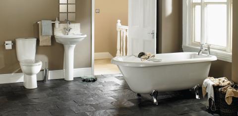 A toilet, a pedestal sink and soaking tub.